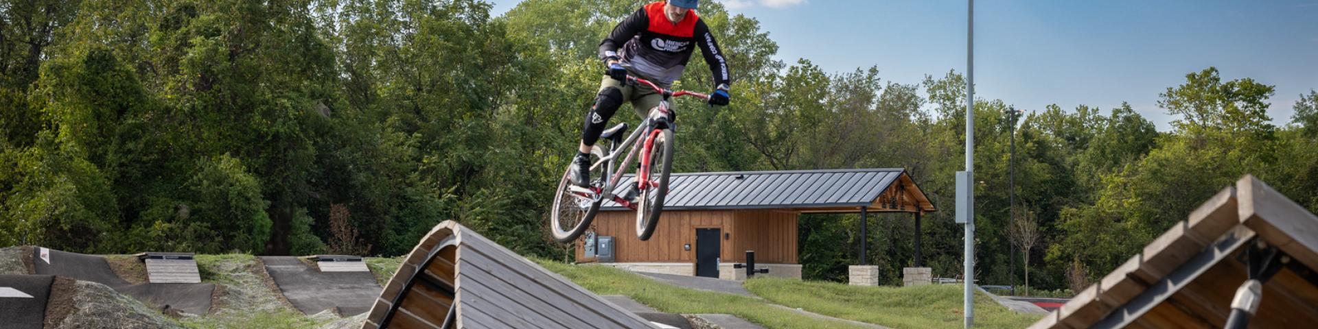 Rider jumping onto expert jump line ramp