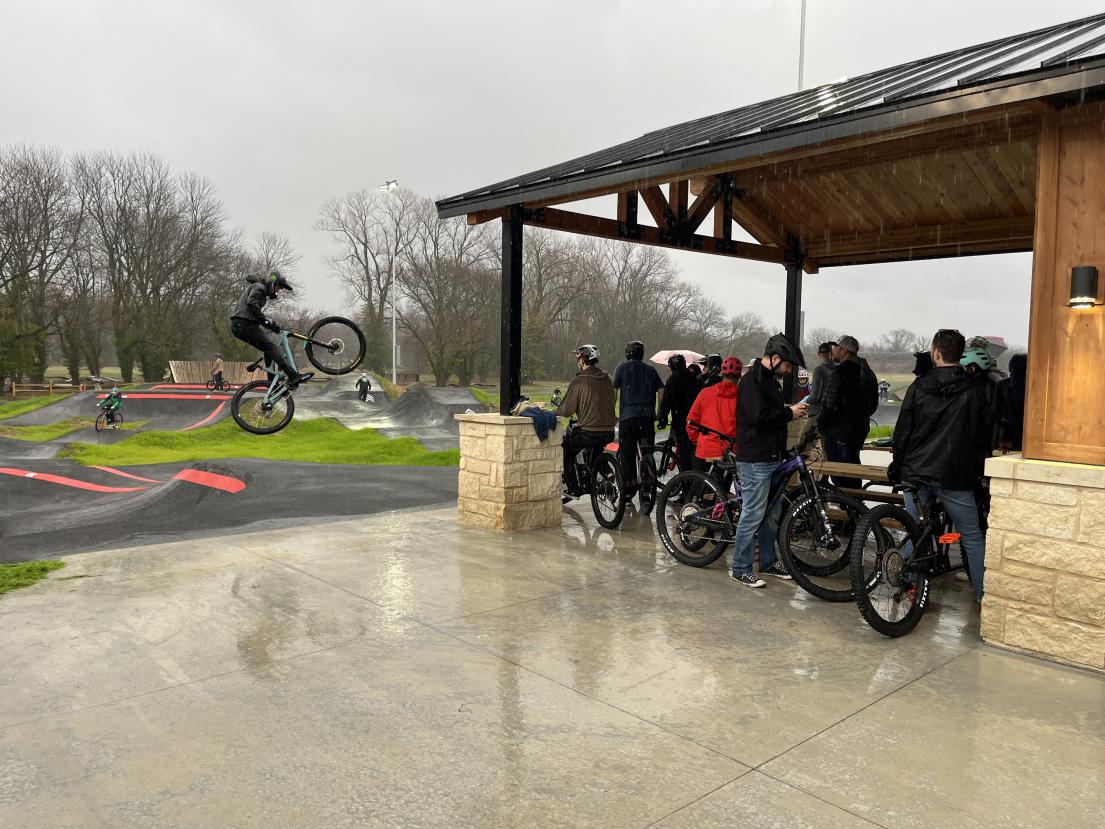 Opening day crowd waiting to ride pump track in the rain
