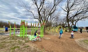 Kids riding near the lilypad forest towards tunnel features