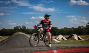 Rider posing on bike on edge of pump track